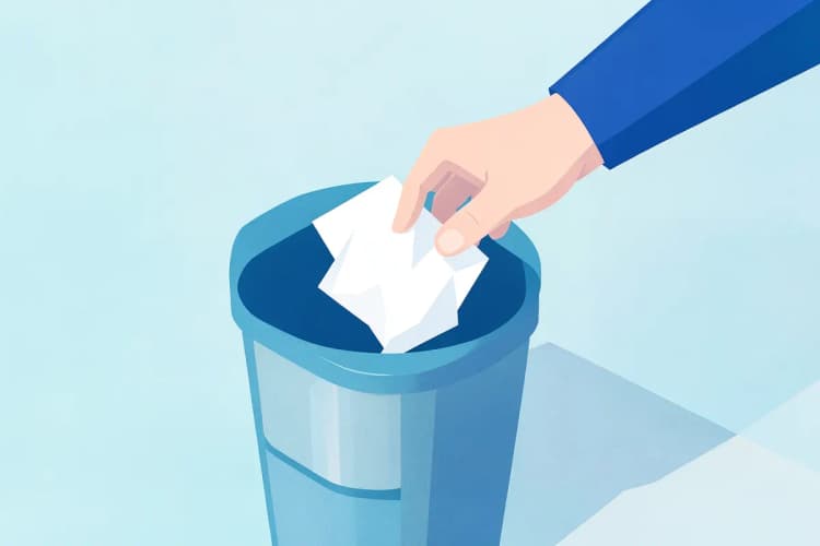 Uma pessoa jogando fora um pedaço de papel amassado em uma lixeira.